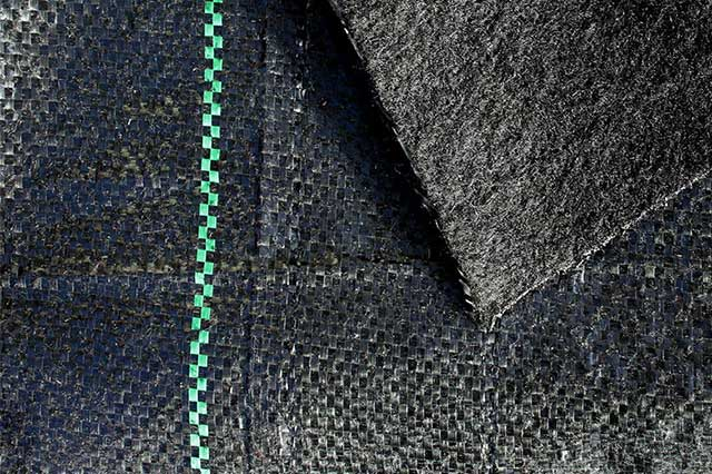Zoomed in on Talon Fabrics geotextile needle punched into a woven ground cover fabric